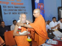 0028 0009 Sri Sri Vishweshateertha Swamiji, Sri Pejawar Math, Udupi is being garlanded by Swami Jitakamanadaji